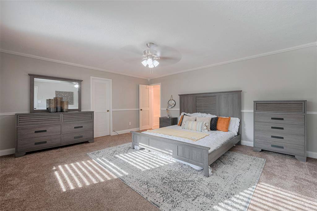 This spacious downstairs bedroom offers a peaceful retreat with soft, natural light streaming through the windows. Featuring neutral tones, and plenty of room for relaxation, this is a sanctuary that invites rest and comfort. Perfect for unwinding after a long day, with easy access to your private ensuite bathroom.