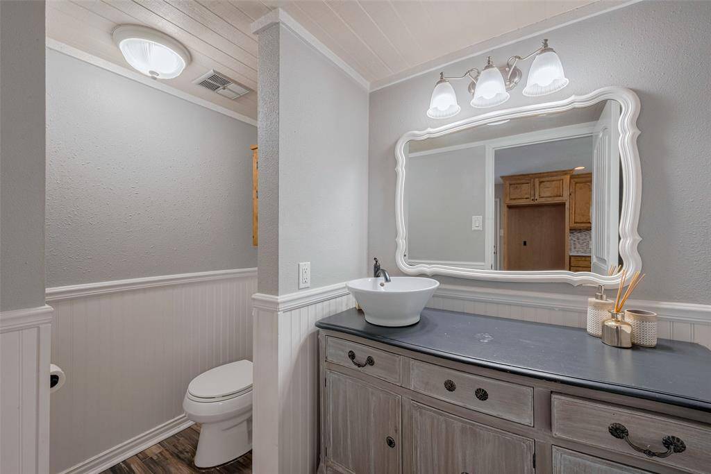 A charming half bath is conveniently located on the first floor, offering both style and functionality.