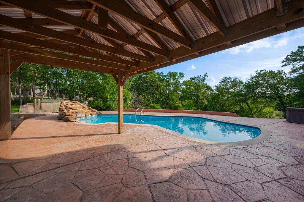 Pool level covered space provides shaded area for the Texas sun and a gathering place for evenings outdoors.