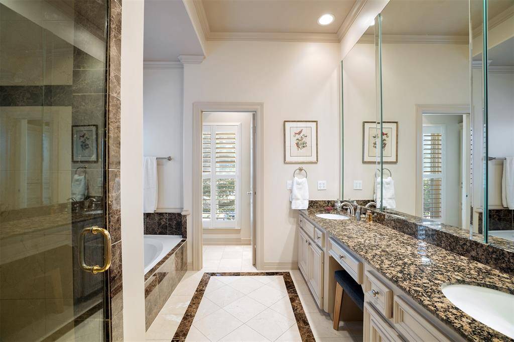 Light-filled granite and stainless kitchen. The breakfast room is the background with views to the backyard garden and lawn.