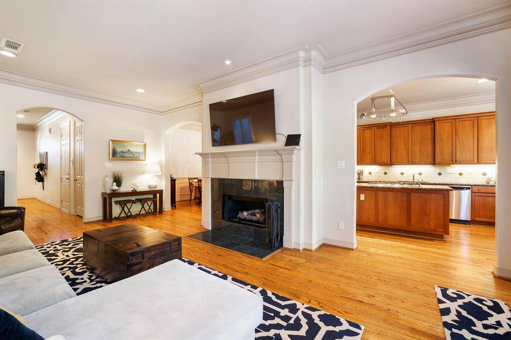 Northern view of the living room with windows and French doors leading to the spacious and lush backyard.