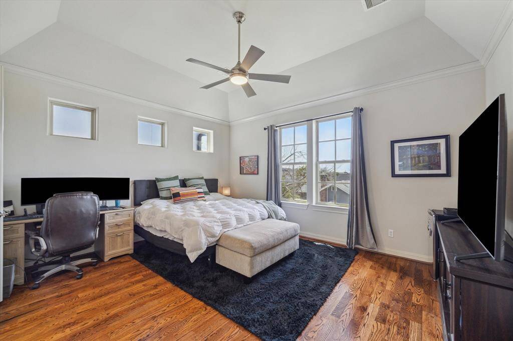 Primary bedroom with hardwood floors, two large closets and lots of natural light.