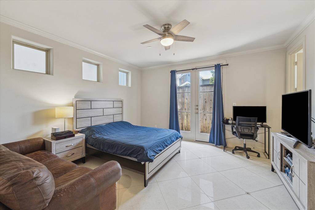 Generous sized bedroom on the first floor with ensuite full bathroom, large walk-in closet and a patio area out the French Doors.