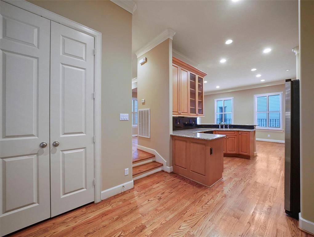 This view showcases the breakfast room's seamless connection to the kitchen, features include double crown molding , and 8" baseboards that enhance the elegance of the space.