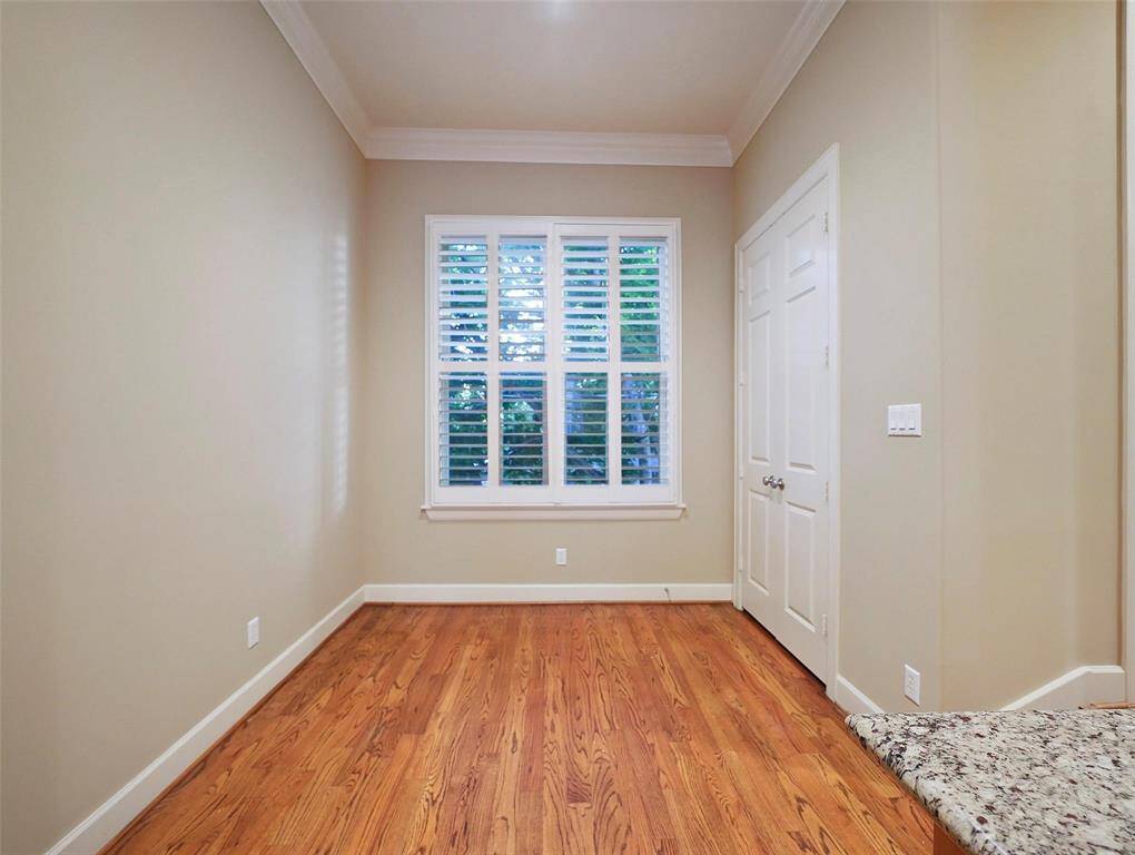 This spacious eating area, open to the kitchen, features a large double door pantry accessible through double 8ft solid core doors (all doors are solid core doors). Wide windows offer serene green views. Custom plantation shutters are found on all windows throughout the home, and add a touch of elegance.