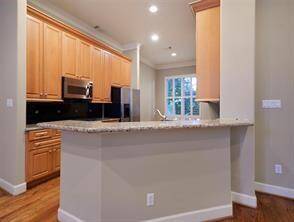 This view highlights the long breakfast bar, offering seating for 4+ bar stools.
