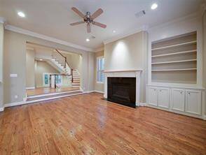 Here's the spacious living room, the dramatic stairwell and landing add an elegant touch to the open and airy space.