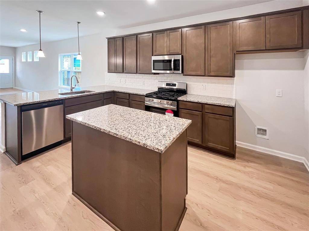 The Cardinal II- Kitchen with Optional Island. Home under construction. Sample floor plan photo used for illustrative purposes only. Upgrades, selections options, windows and colors may vary.