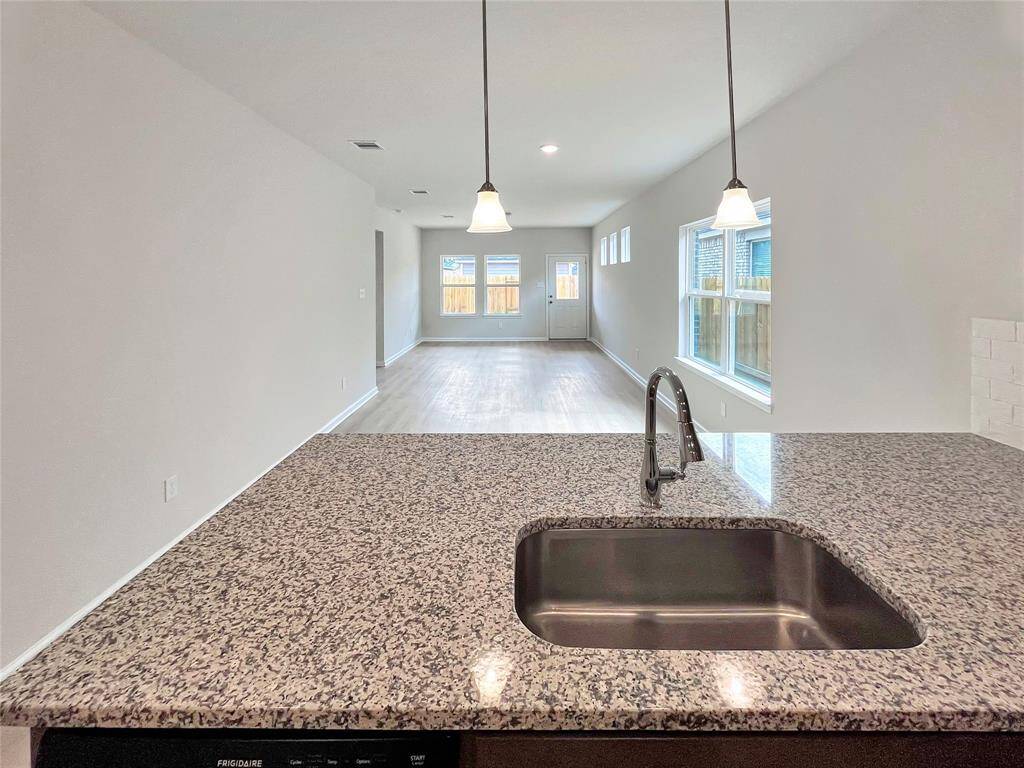 The Cardinal II- Kitchen into Breakfast Area/Family Room. Home under construction. Sample floor plan photo used for illustrative purposes only. Upgrades, selections options, windows and colors may vary.
