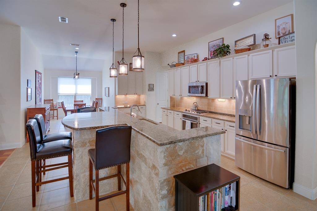 The kitchen opens up to a bright and airy dining area, perfect for enjoying meals with loved ones.