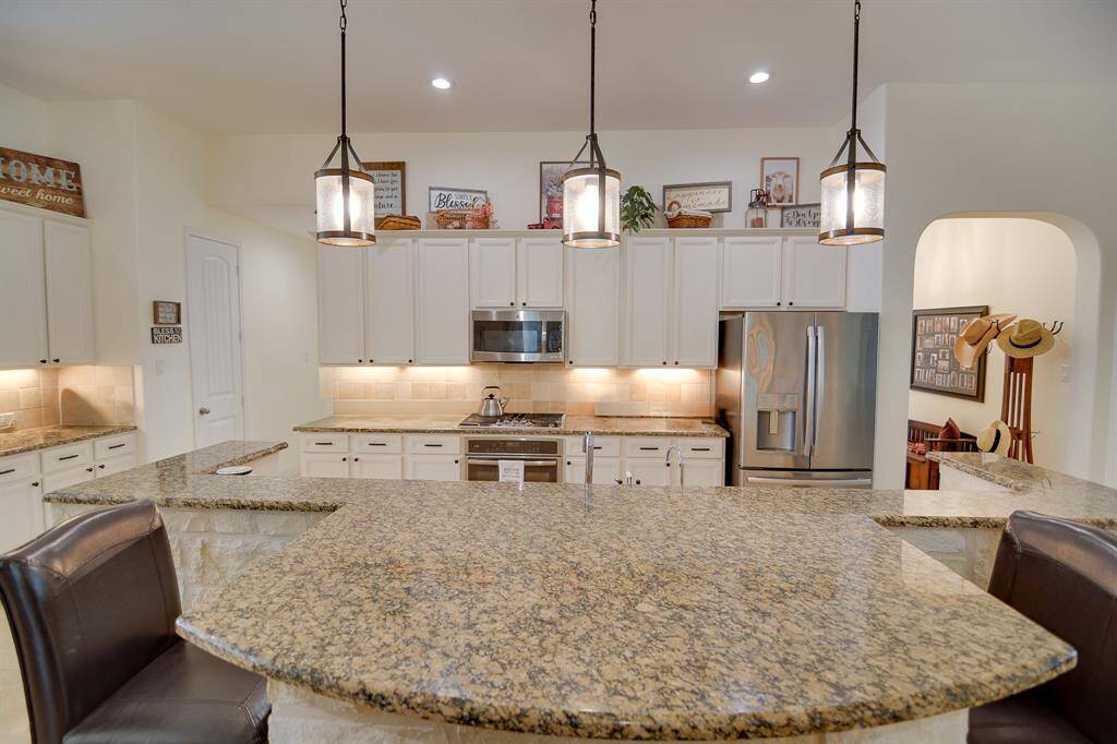 The heart of this home is the chef's dream kitchen, a true centerpiece that will inspire culinary creativity. It features top-of-the-line appliances, expansive countertops, and ample storage, making it ideal for preparing everything from casual family meals to elaborate dinner parties.