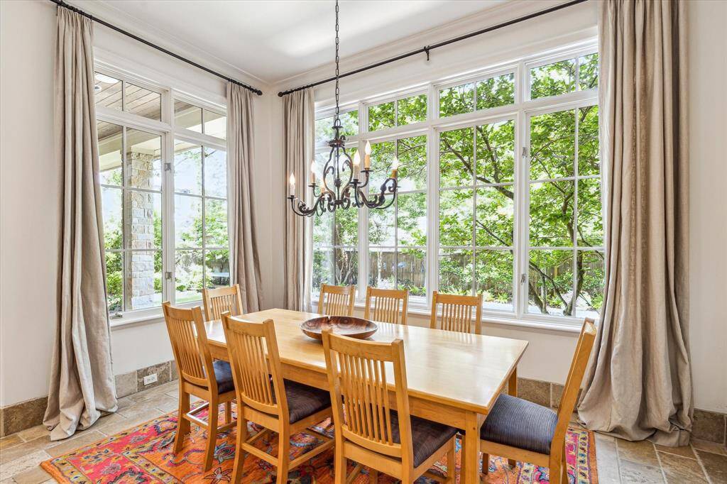 Savor meals in this light and bright breakfast room, perfectly positioned to overlook the serene backyard, pool, and back patio - adjacent to the gourmet kitchen, it's ideal for seamless daily living.