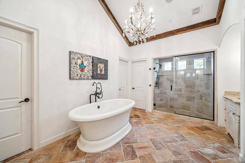 Stunning freestanding tub, and sleek glass-enclosed shower, offering modern luxury.