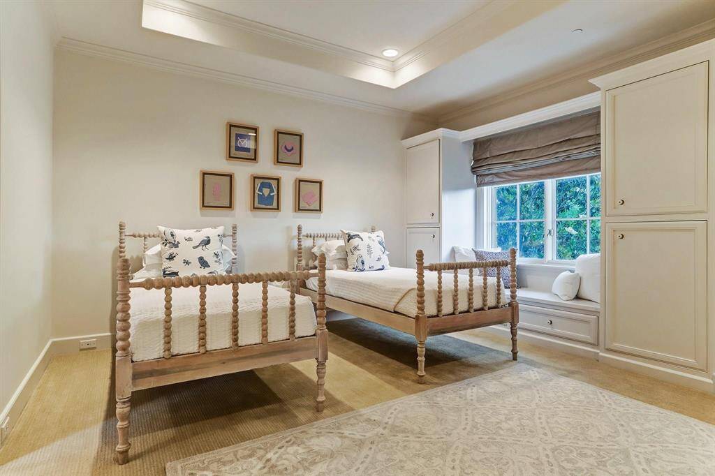 Spacious bedroom #2 offers is a welcoming retreat with built-in cabinetry and a window seat.