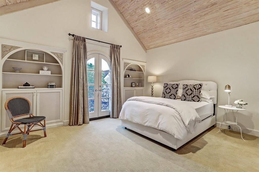 Bedroom #3 features a vaulted ceiling with bleach beaded wood, beautiful built-ins, a Juliet balcony, good size walk-in closet and private bath with white marble floors and counter tops.