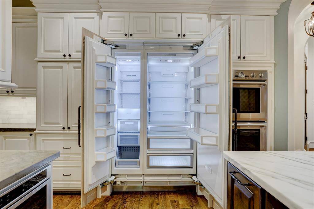 Large Thermador refrigerator camouflaged in the cabinetry