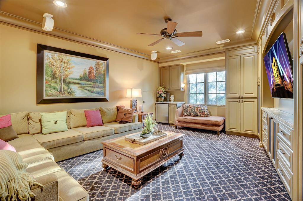 Theater-style carpet in media room with built in cabinetry