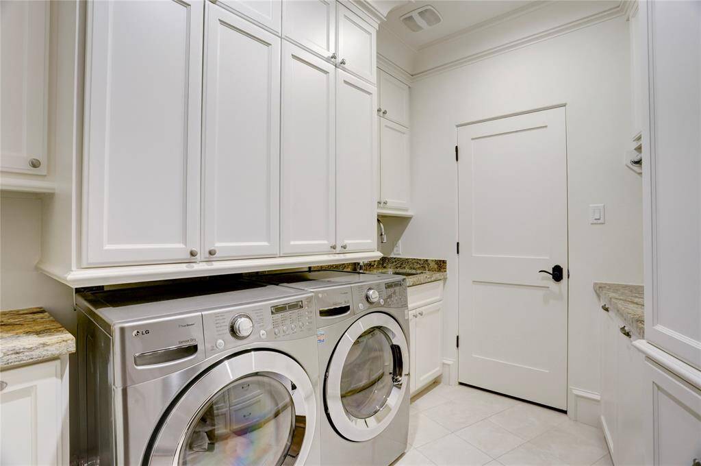 Laundry room on the Primary 2nd floor with great storage and a full storage through the door