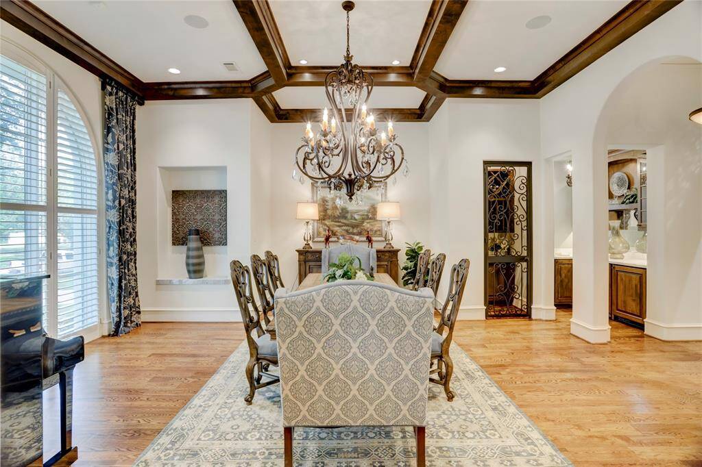 Dramatic boxed beam ceiling in dining room serviced by a wine room and butler’spantry