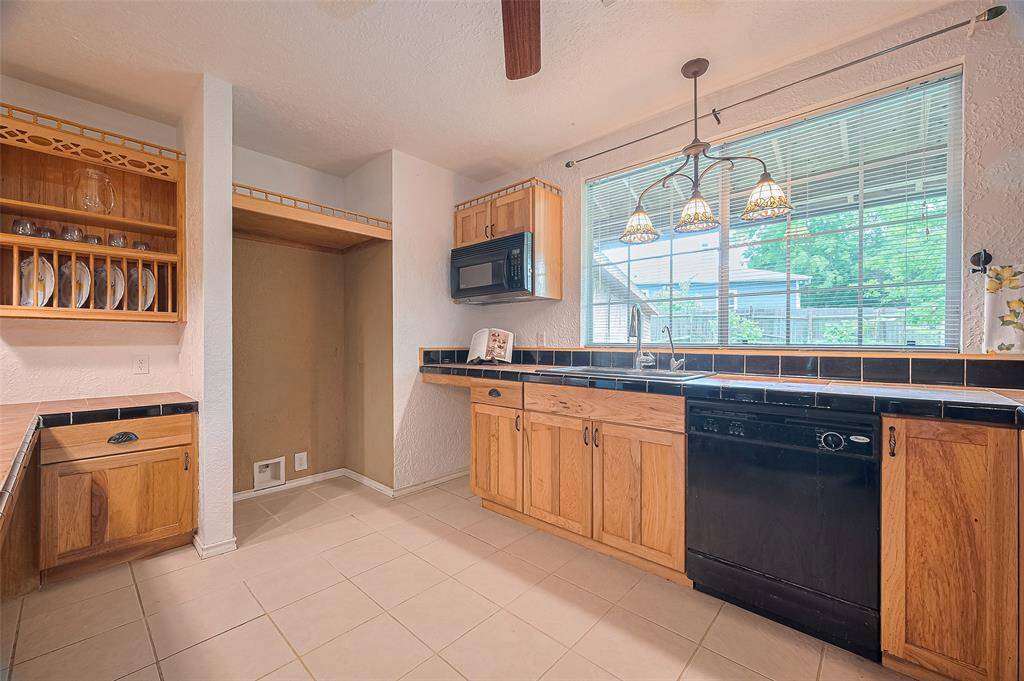 The kitchen boasts warm, classic style with its wood cabinetry and complementary wood details.