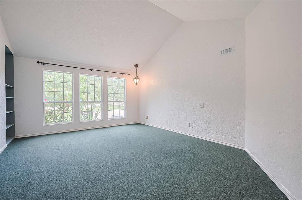 The primary bedroom offers ample space and bright and sunny windows.