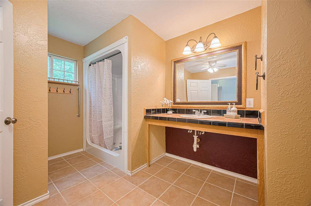 The bathroom in this home is ADA-compliant and offers plenty of space for comfortable use.