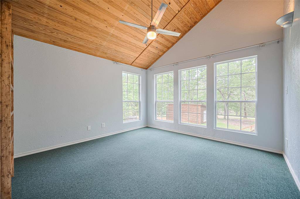 The Lake room, with views of the lake, featuring soaring wood-paneled ceilings.