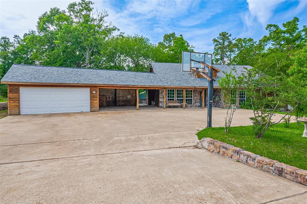 This cabin boasts a convenient carport and offers abundant space to accommodate multiple vehicles
