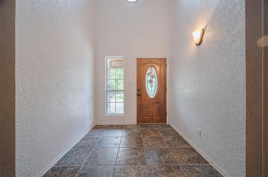 A skylight above the door fills the entryway with natural light.