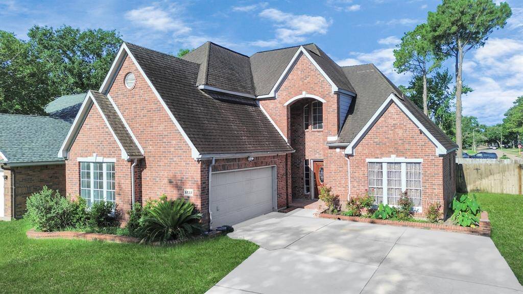 Charming two-story brick home with a gable roof and attached two-car garage. It features a well-maintained front yard with lush greenery, a spacious driveway, and large windows for ample natural light. Ideal for families seeking a welcoming suburban neighborhood.