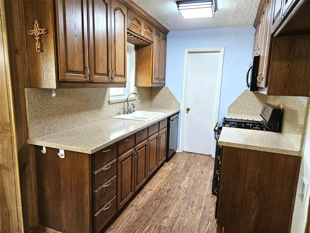 Kitchen has updated cabinets and countertops.