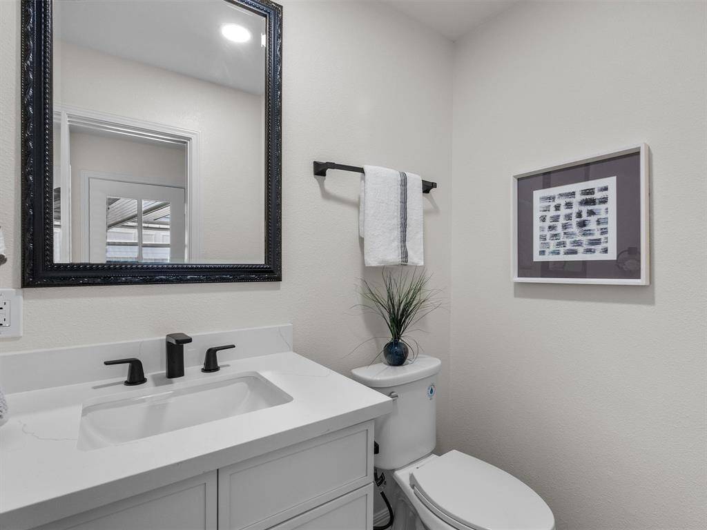 The convenient half bath is located near the rear entry and in-house utility room.