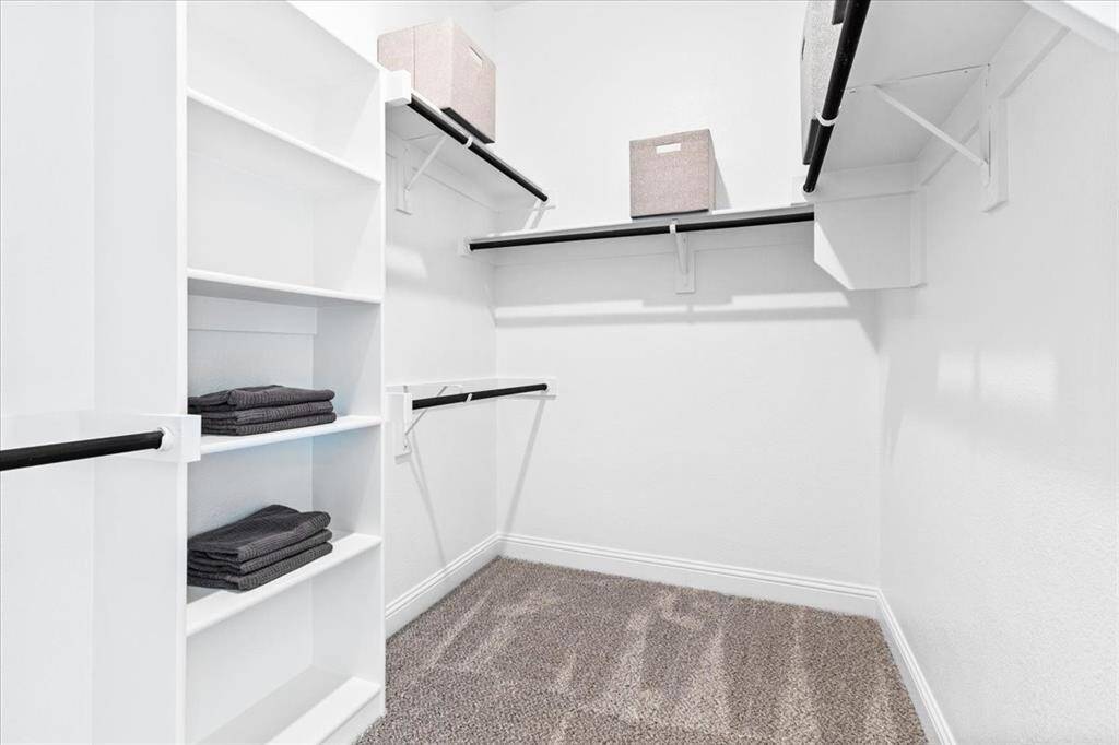 Representative photo of the Hawthorn II plan Primary Closet. Shown to highlight as you glide through the spacious layout, you'll appreciate the thoughtful design elements that make getting ready a joy.