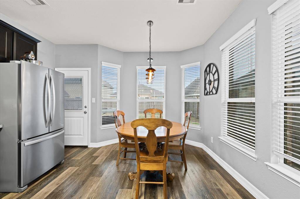 Breakfast area with large bay windows and door to patio.