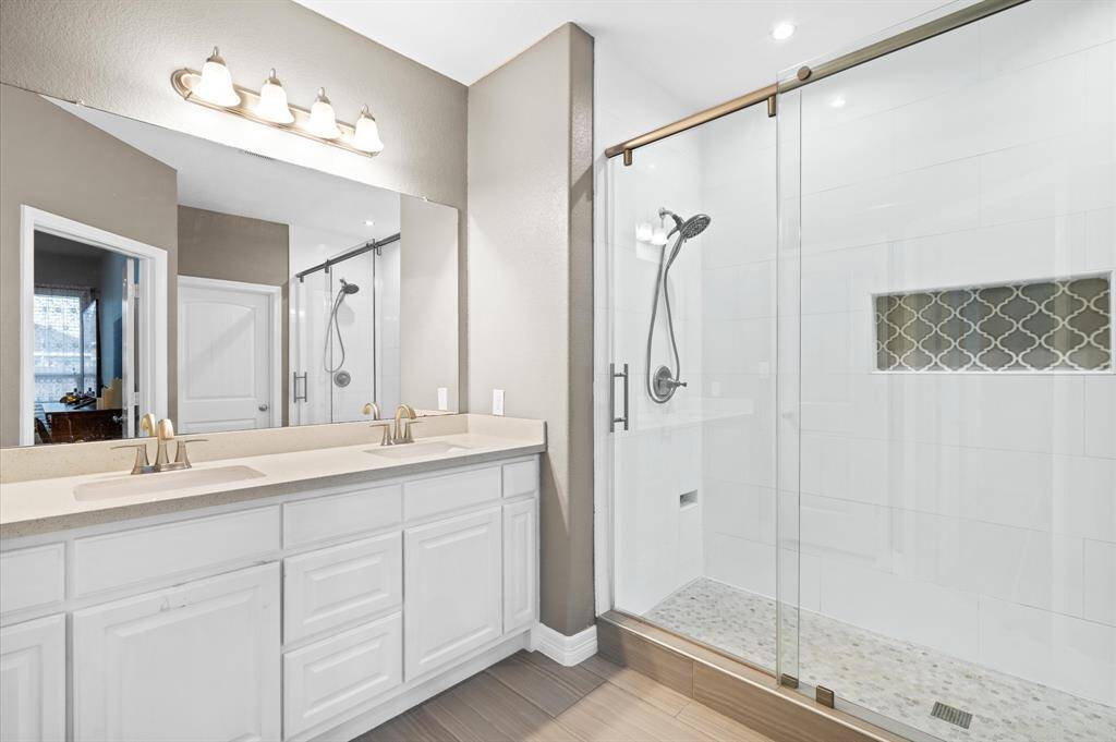 Primary bath with double sinks and massive vanity with tons of storage