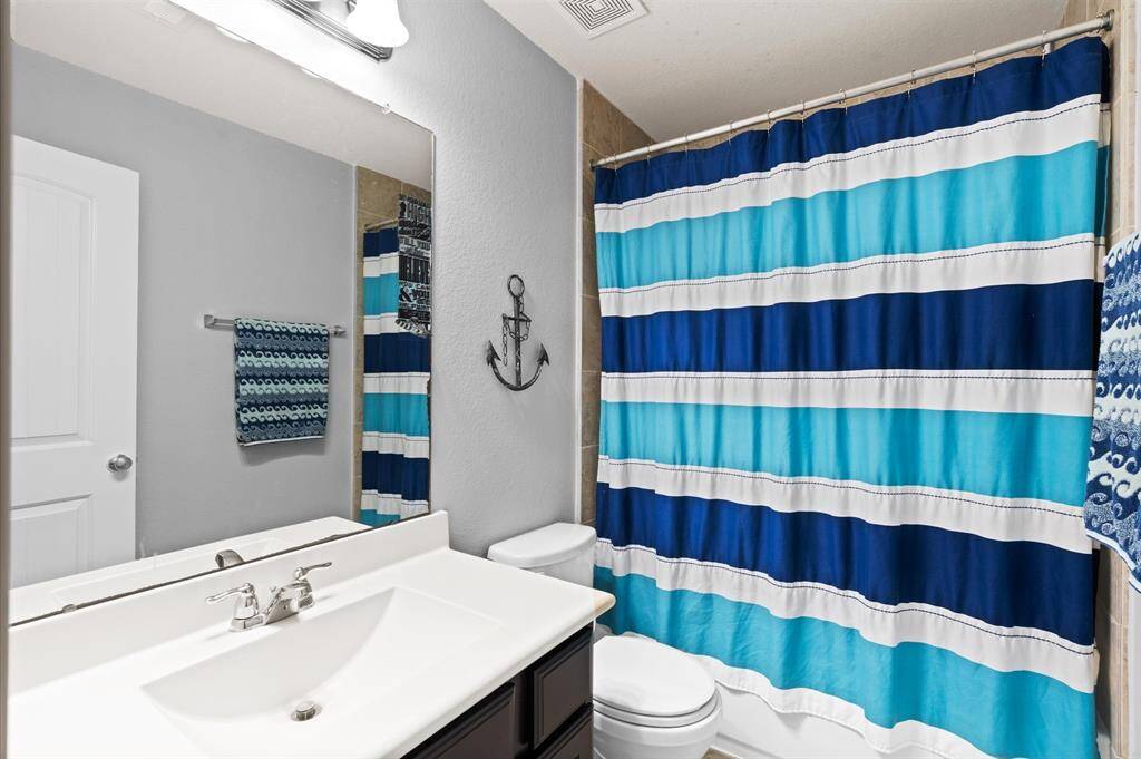 Guest bathroom located upstairs.