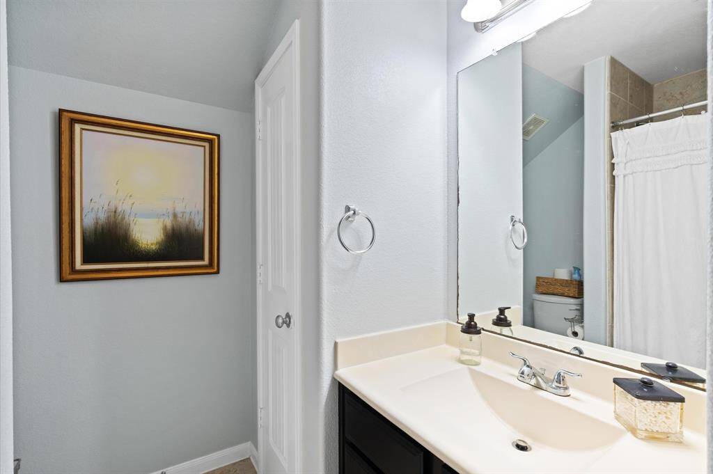 Second bathroom with vanity area and tub/shower combo.