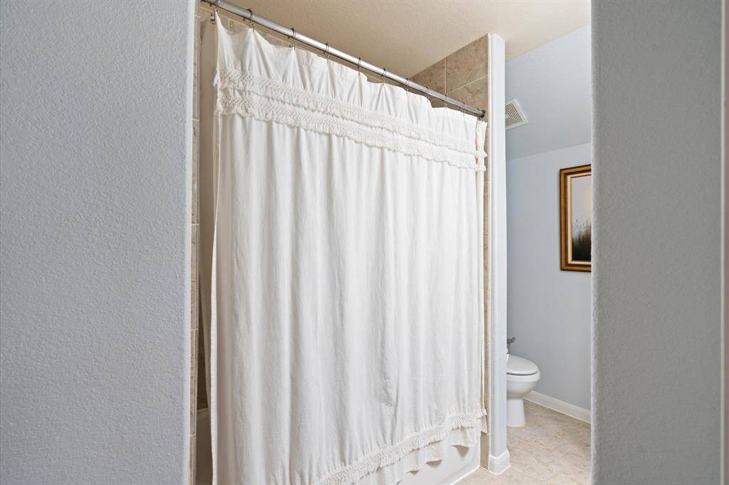 Second bath has a ceramic tile tub shower surround