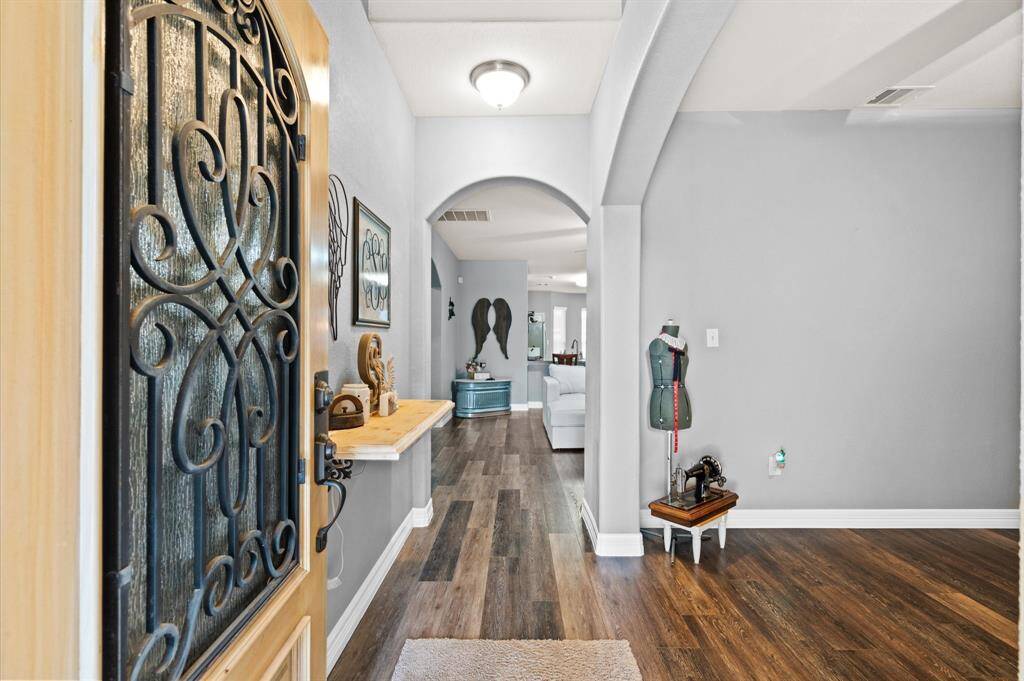 Entry into the home with study/formal living to the right. Notice the arched doorways.