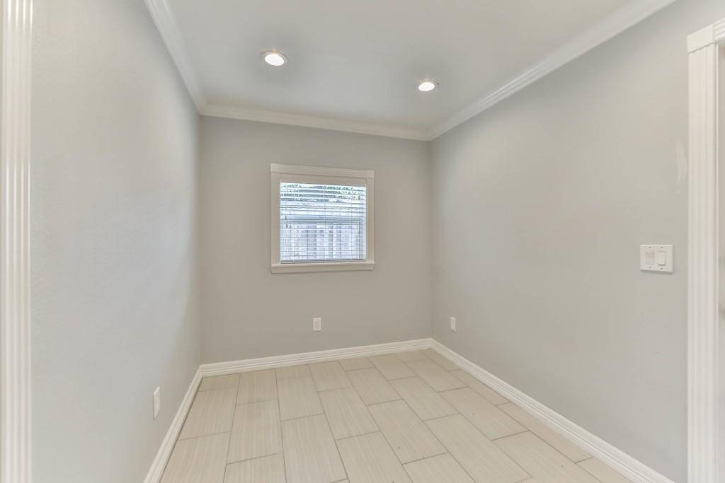 With crown molding, recessed lighting, & fluted architectural design trim around doorways & windows, as seen in the breakfast room...