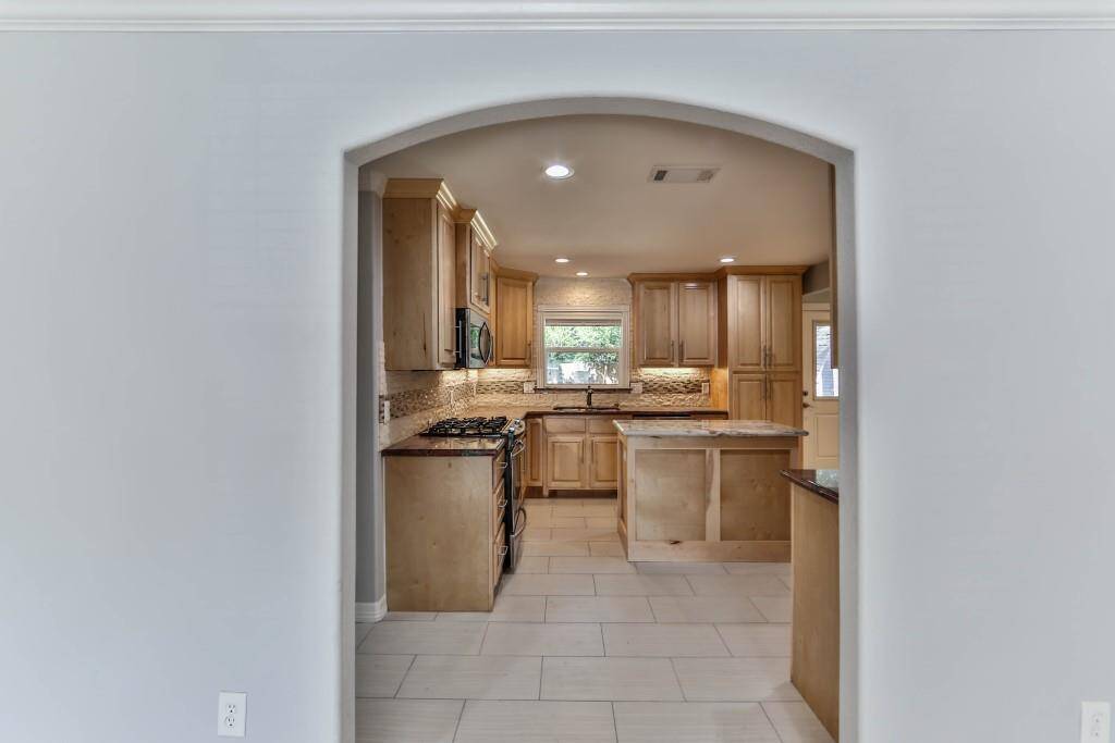 You'll find rectified tile flooring in the kitchen & bathrooms, as well as on-site built maple cabinetry...