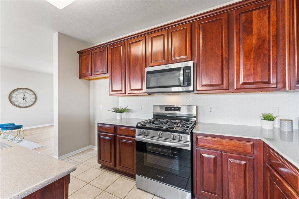 Gleaming countertops, modern appliances, and generous cabinetry make cooking a joy and cleanup a breeze.