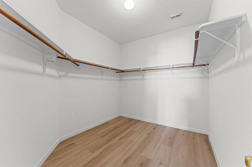 Step into a spacious walk-in closet designed with organization in mind, it offers ample space for all your wardrobe essentials.