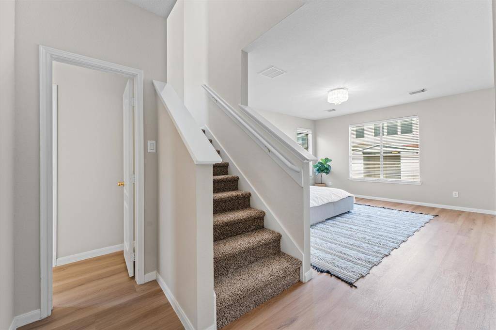 A charming staircase leads to a private upstairs den—perfect as a home office, reading nook, or nursery.