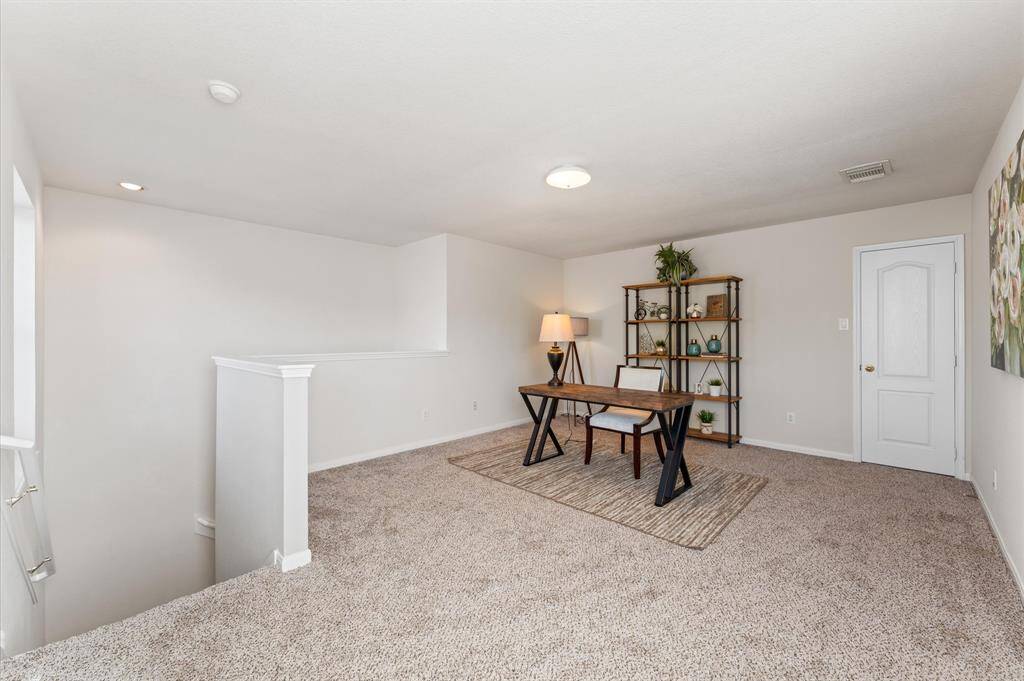 Tucked away above the master suite, this cozy den is a delightful bonus space full of potential.