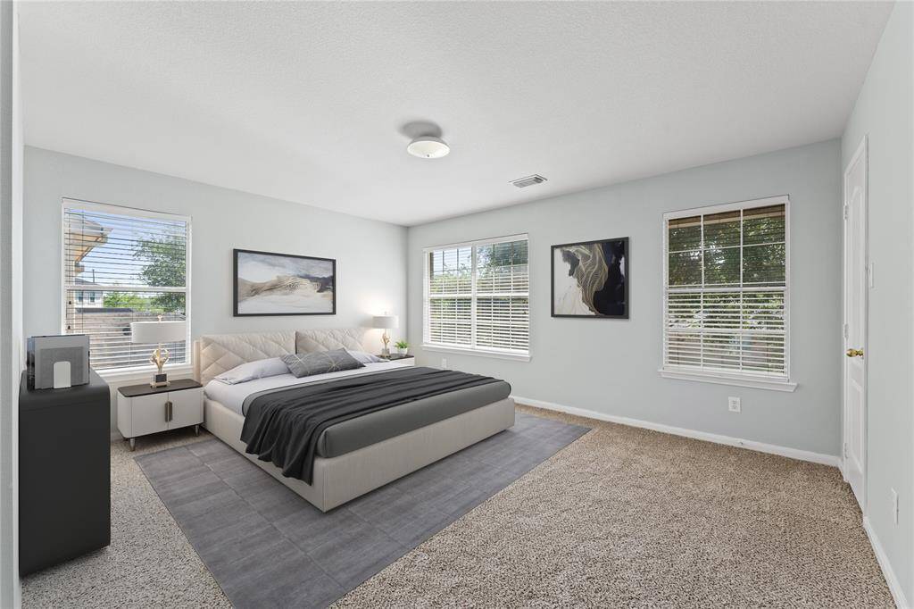 This charming fourth bedroom offers a blend of comfort and versatility. Generously sized, it can easily be transformed into a guest room, playroom, or study. The soft carpet and large windows create a cozy environment for relaxation and productivity alike.