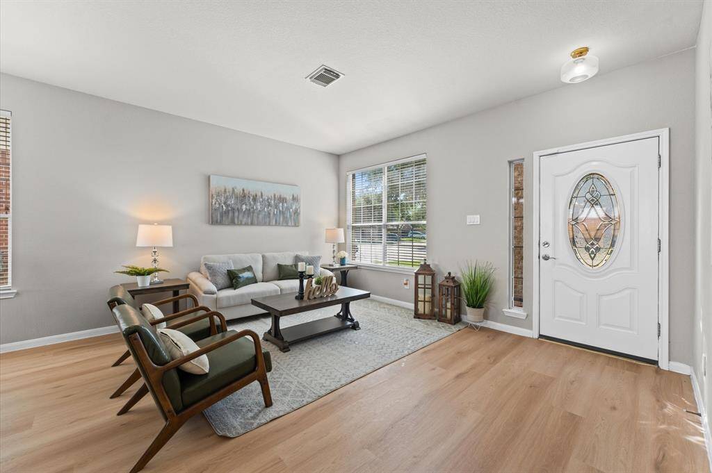 Step into a home that welcomes you with warmth and charm from the moment you walk through the door. The fresh vinyl flooring sparkles under soft natural light, setting a tone of clean elegance.