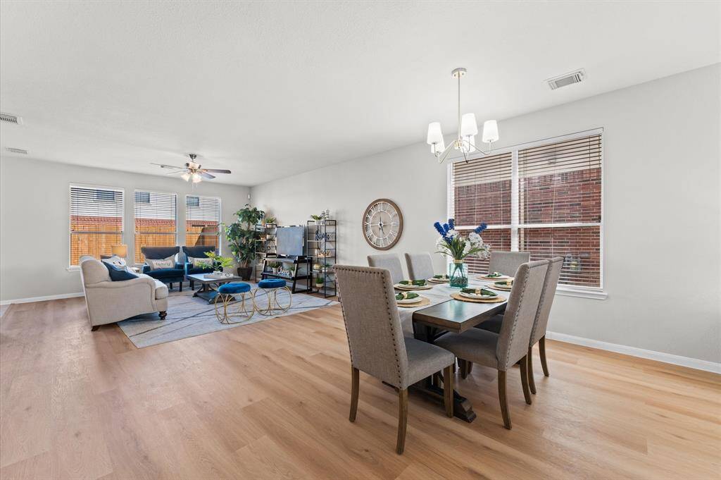 Share meals and moments in a dining space that radiates warmth. This inviting area is nestled perfectly within the open layout, ideal for both family dinners and special celebrations.