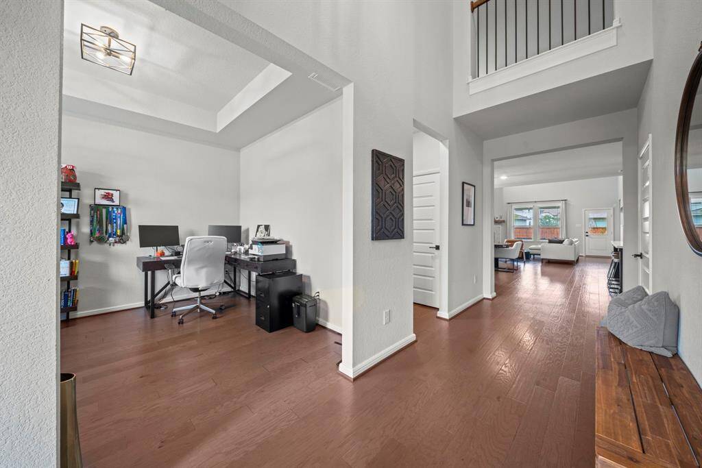 The front room is super flexible, and can be used as a home office, formal dining room, or sitting/living area. Beautiful hardwood flooring flows from the front to the back door.
