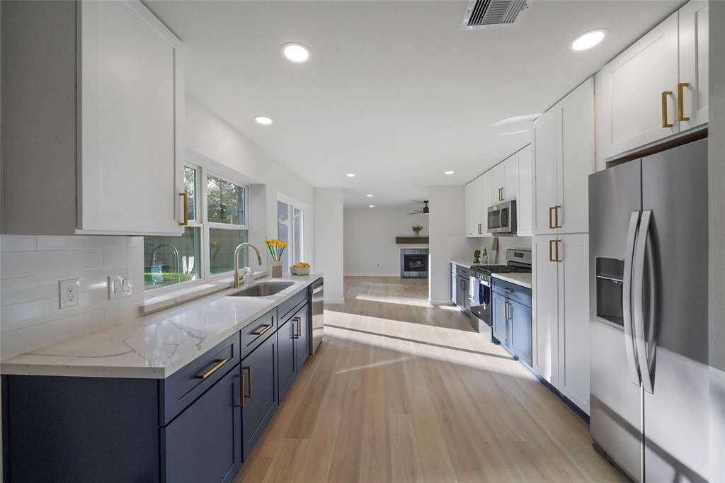 Loads of storage space with two toned cabinetry and pantry,